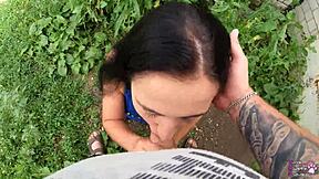 the horny student with long hair and brown eyes gives a sloppy blowjob behind the garages