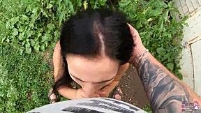 the horny student with long hair and brown eyes gives a sloppy blowjob behind the garages