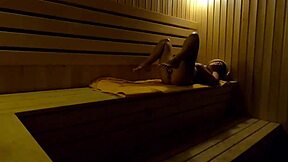 Caught on hidden cam, girl fingers herself in sauna at night