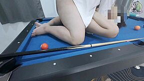 thai girl in uniform climbs pool table for fun game in dorm