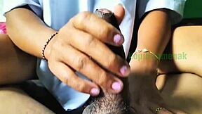 Asian couple practicing handjob techniques outdoors in a homemade video.