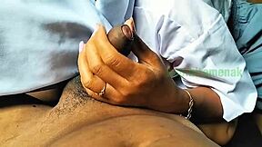 Asian couple practicing handjob techniques outdoors in a homemade video.