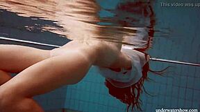 Lola shows her big natural tits while swimming underwater.