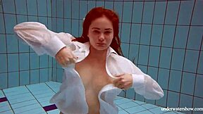 Lola shows her big natural tits while swimming underwater.