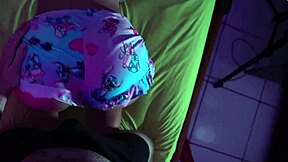 A petite cute girl gives a handjob over underwear, leading to orgasm