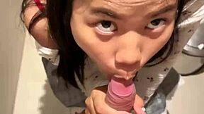 18-year-old asian girl gives blowjob in public restroom, ending with huge cumshot on her face