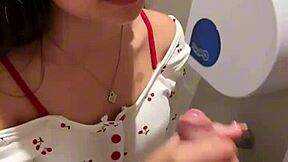 18-year-old asian girl gives blowjob in public restroom, ending with huge cumshot on her face