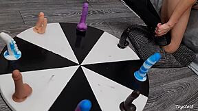 She desperately wants to win her orgasm on the wheel of dildos