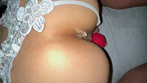 Little Asian girl in white thong enjoys playing with toys