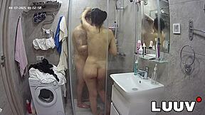 I join my boyfriend in the shower with webcam on, showing my shaved pussy.