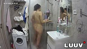 I join my boyfriend in the shower with webcam on, showing my shaved pussy.