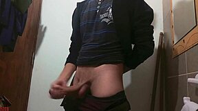 Skinny girl masturbates big cock in bathroom