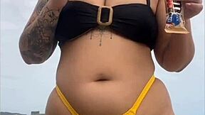 look at my swollen pussy in tight yellow bikini on beach