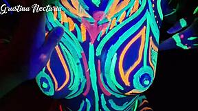 Wild slim brunette girl with long hair gets fucked doggystyle by big cock in UV light.