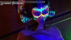 Wild slim brunette girl with long hair gets fucked doggystyle by big cock in UV light.