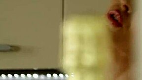 HOUSEWIFE GOING CRAZY in the kitchen with lipstick and natural tits showing through panties.