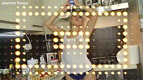 HOUSEWIFE GOING CRAZY in the kitchen with lipstick and natural tits showing through panties.