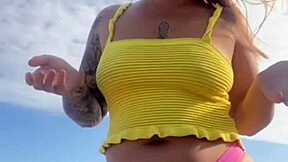 Hey, check out this young exhibitionist flashing her puffy pussy lips in bikini at the beach