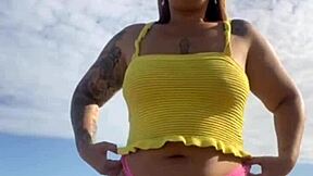 Hey, check out this young exhibitionist flashing her puffy pussy lips in bikini at the beach