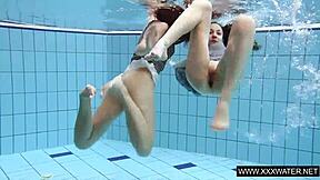 shaved brunette babe with big tits teases subtly in underwater pool bathing session with tight body