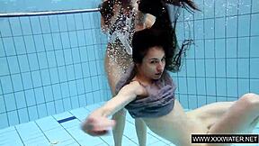 shaved brunette babe with big tits teases subtly in underwater pool bathing session with tight body