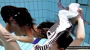 shaved brunette babe with big tits teases subtly in underwater pool bathing session with tight body