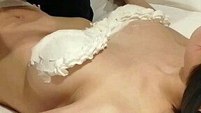 Amateur homemade video where I craft a cream-decorated bra on my busty girlfriend's breasts in bedroom.