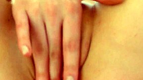 Brunette teen beauty Hostia T casually fingers her shaved tight pussy on the bed like a total slut