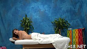 beautiful young woman gets a thorough massage from her skilled rubber. she enjoys the relaxing session outdoors.