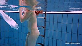 redhead marketa teases in white dress by the pool