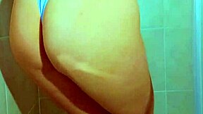 College beauty's Brazilian thong shower tease shows shaved pussy and big ass in homemade video