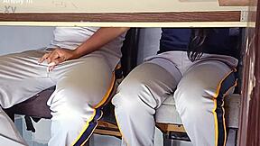 In a forbidden classroom game, the hot college girl flashes her uniform. She rides the desk wildly in a quickie with her student friend.