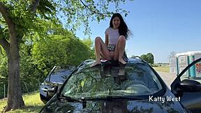 Crazy girl pees on car roof for windshield cleaning