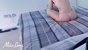 Sexy girl in bra and panties plays computer games on bed in homemade solo fetish