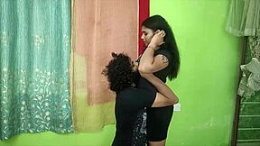 In a cozy bedroom, the cute young Indian couple shares sweet kisses and tender romantic moments together as loving husband and beautiful housewife.