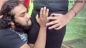 In a cozy bedroom, the cute young Indian couple shares sweet kisses and tender romantic moments together as loving husband and beautiful housewife.