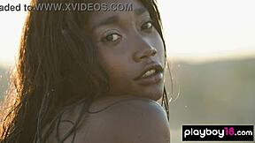 Ebony teen Mimi Desuka smokes a cig while stripping big natural tits on sunny rooftop unwind